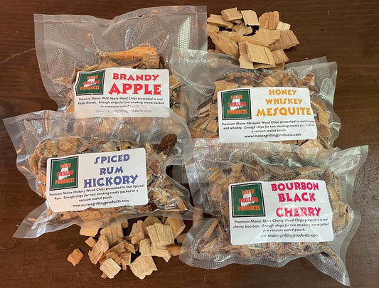 PRE-SOAKED MAINE WOOD CHIPS VARIETY PACK (ONE EACH 6 OZ POUCH) BRANDY APPLE, HONEY WHISKEY MESQUITE, SPICED RUM HICKORY, AND BOURBON BLACK CHERRY by Flame Grilling Products Inc
